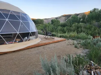 a dome building with a bench on a wooden deck at D6 Sahara Sunset- King Suite Very Private in Drumheller
