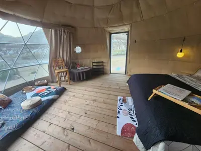 a room with a bed and a window in a tent at D6 Sahara Sunset- King Suite Very Private in Drumheller