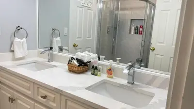 a bathroom with two sinks and a shower at Warm home in Richmond