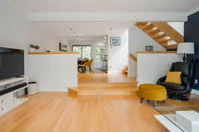 a living room with a chair and a table at 4BR in Blueberry Hill Estates, Mountain Views, Large Family Home, Wood Fireplace, Balcony in Whistler