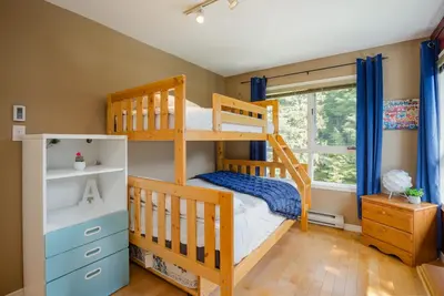 a bedroom with two bunk beds and a window at 4BR in Blueberry Hill Estates, Mountain Views, Large Family Home, Wood Fireplace, Balcony in Whistler