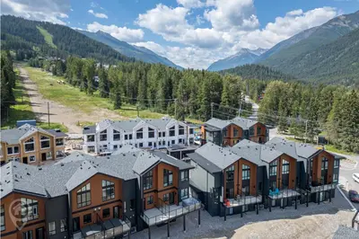 an aerial view of a resort with houses and mountains at Nordix Townhomes by StayIn in Panorama