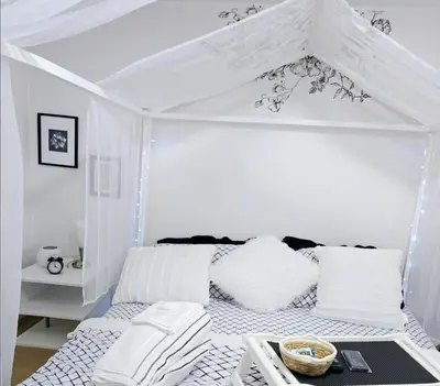 a white room with a bed with a canopy at Lovely Cozy Room! with Attached Private Bath in the Heart of Vancouver! Private Parking & Self Check-in! in Vancouver