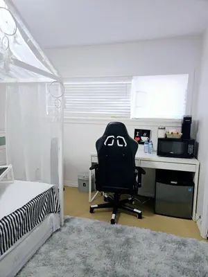 a bedroom with a desk and a computer chair at Lovely Cozy Room! with Attached Private Bath in the Heart of Vancouver! Private Parking & Self Check-in! in Vancouver