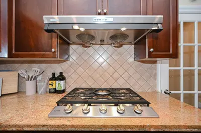 a stove top oven sitting in a kitchen at Beautiful Dunbar Home in Vancouver