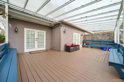 a room with a deck with benches and a building at Beautiful Dunbar Home in Vancouver