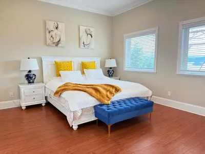 a bedroom with a bed and a blue ottoman at Blue House in Gibsons
