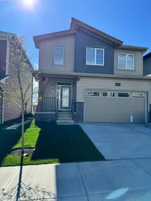a house with a driveway and a garage at Private Modern Retreat in the NW - 12 mins to Airport - Near Shops - Easy Banff Access in Calgary