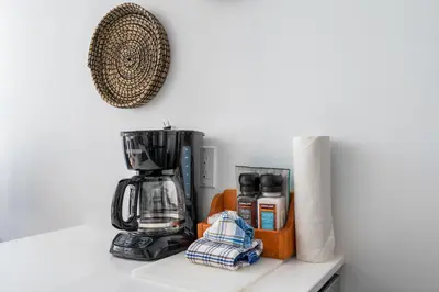 a counter top with a coffee maker and a coffeemaker at a fully renovated condo near village centre with MT view and close to lift in Cascade lodge in Whistler