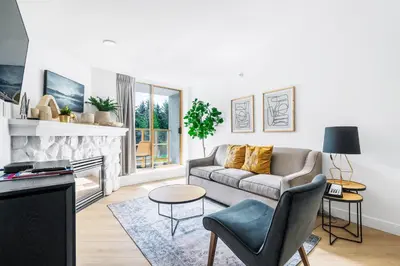 a living room with a couch and a fireplace at a fully renovated condo near village centre with MT view and close to lift in Cascade lodge in Whistler