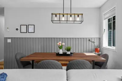 a dining room with a wooden table and chairs at B111 Hot tub, ACx3, parking, coin laundry, near Banff in Canmore