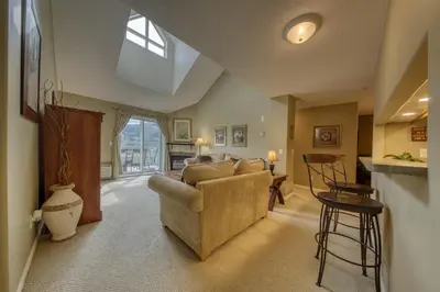 a living room with a couch and a table at The Peaks 3 Bedroom Mountain View Condo in Radium Hot Springs
