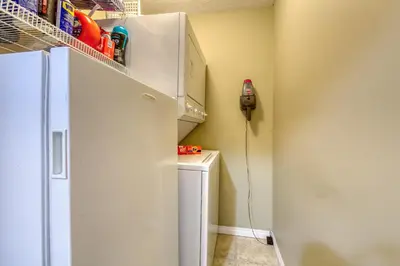 a kitchen with a refrigerator and a phone on the wall at The Peaks 3 Bedroom Mountain View Condo in Radium Hot Springs