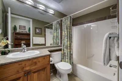 a bathroom with a sink and a toilet and a shower at The Peaks 3 Bedroom Mountain View Condo in Radium Hot Springs