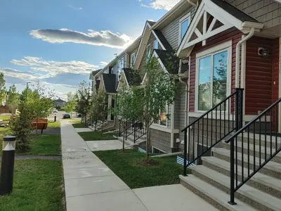 a house with a sidewalk in front of it at Genesis Townhouse in Calgary