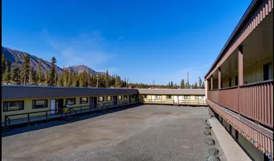an empty parking lot in front of a building at Talbot Arm Motel in Destruction Bay