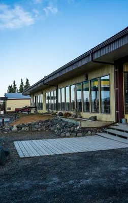 a building with a bunch of windows on it at Talbot Arm Motel in Destruction Bay