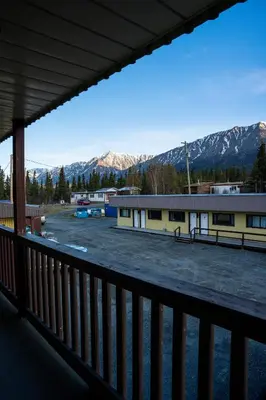 a view of a parking lot with mountains in the background at Talbot Arm Motel in Destruction Bay