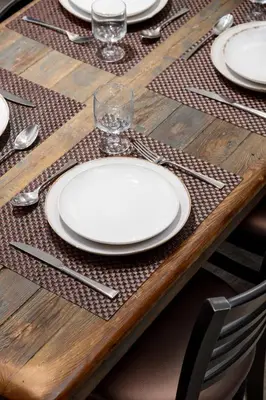 a wooden table with white plates and silverware on it at Spacious 3BR Condo in Whistler in Whistler