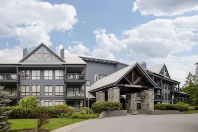 an exterior view of a large building with a driveway at Spacious 3BR Condo in Whistler in Whistler
