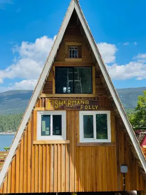 a wooden house with a sign on it at Fishermans Folly in Lund