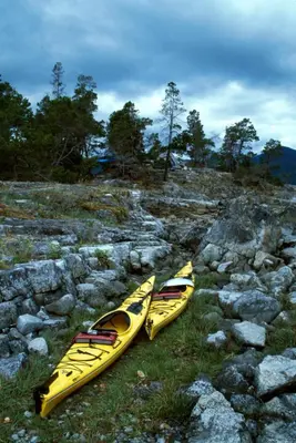 two yellow kayaks sitting on top of a rocky hill at Shannaghs Sweet Escape in Powell River