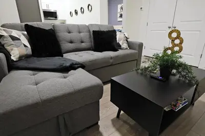 a living room with a couch and a coffee table at Elegant Escape with King Bed, Long Stays, WEM, Disney in Edmonton