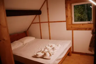 a bedroom with a bed with white towels on it at Rustic Basic Cabin at Beaverfoot in Parson