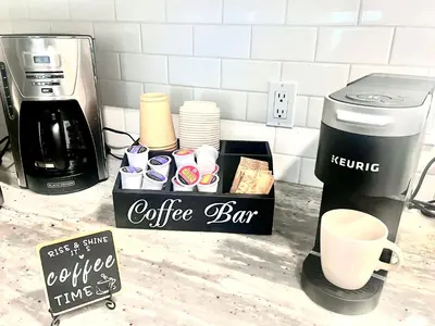 a coffee bar on a counter next to a coffee maker at Spacious & Comfy Upper Floor 3BR Suite in Detached House in Calgary