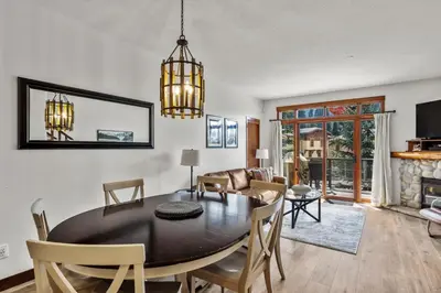 a dining room and living room with a table and chairs at Trappers Landing #30 townhouse in Sun Peaks