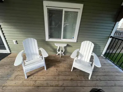 two chairs and a table on a porch at James house J&J Chilliwack in Chilliwack
