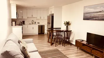 a living room with a couch and a table and a kitchen at #304 Mountain View 1BR in Canmore DT in Canmore