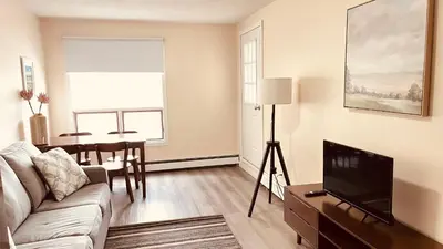 a living room with a couch and a television at #304 Mountain View 1BR in Canmore DT in Canmore
