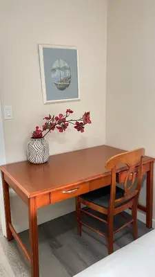a wooden desk with a vase of flowers on it at #304 Mountain View 1BR in Canmore DT in Canmore