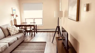 a living room with a couch and a table at #304 Mountain View 1BR in Canmore DT in Canmore