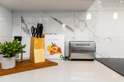 a kitchen counter with a microwave and a book at Beautiful Elegant Home Sleeps 10, Free Parking, Central AC in Edmonton