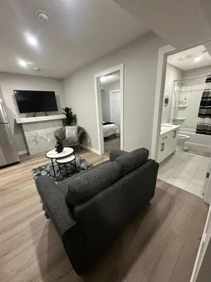 a living room with a couch and a table at Luxurious Home in NW Calgary, Free Parking, High Speed Internet, Near Grocery and Airport in Calgary
