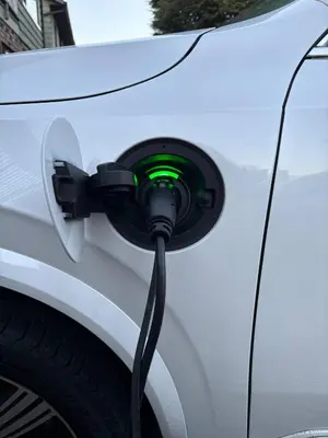 a car with a green light plugged into a charger at Quiet Area Near Downtown Walkable To Cafes in Maple Ridge District Municipality