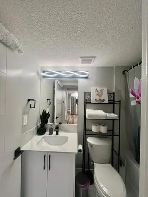 a bathroom with a white toilet and a sink at Adorable Private Suite in Seton SE, Calgary in Calgary