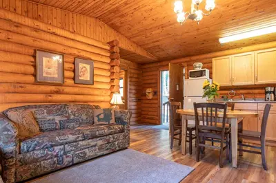 a living room with a couch and a table in a cabin at Cusheon Lake Resort in Ganges