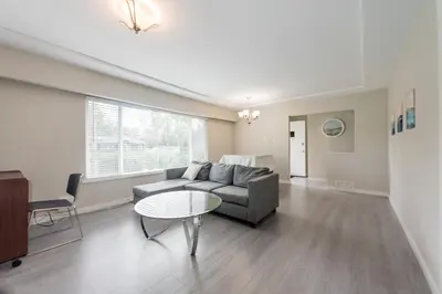 a living room with a couch and a table at Burnaby Metrotown 3 bedroom upstairs in Burnaby