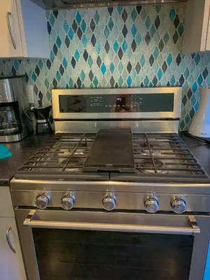 a stove top oven sitting in a kitchen at Windslow Guest Suite at Kye Bay in Comox