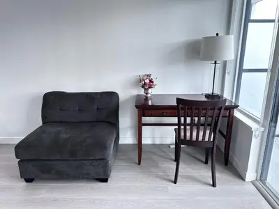 a chair and a desk with a chair and a chair at Relocation Special-New condo at Metrotown in Burnaby