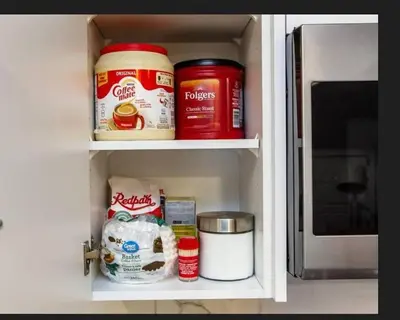 a kitchen cabinet with food items inside of it at Warm getaway Perfect for 4 in Edmonton