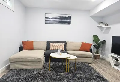 a living room with a couch and a table at Guest Suite in Southeast Calgary in Calgary