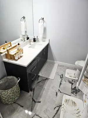 a bathroom with a sink and a mirror at Guest Suite in Southeast Calgary in Calgary
