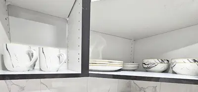 a shelf with white bowls and plates on it at Guest Suite in Southeast Calgary in Calgary