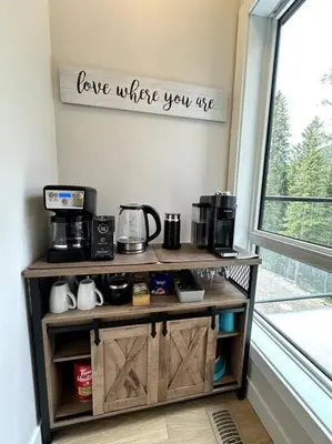 a coffee cart with a sign that reads love where you are at Private Hot Tub Ski In Ski Out Sleeps 9 in Panorama