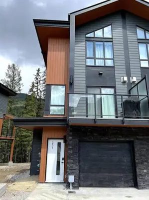 a large house with a white door and windows at Private Hot Tub Ski In Ski Out Sleeps 9 in Panorama