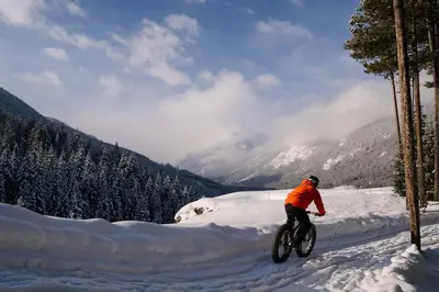 a person riding a bike in the snow at Private Hot Tub Ski In Ski Out Sleeps 9 in Panorama